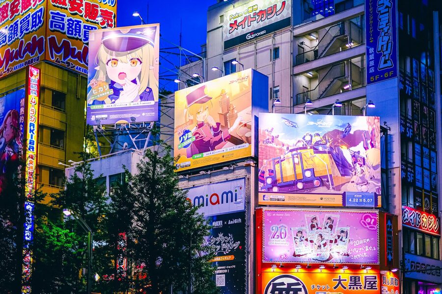Akihabara street at night with anime billboards