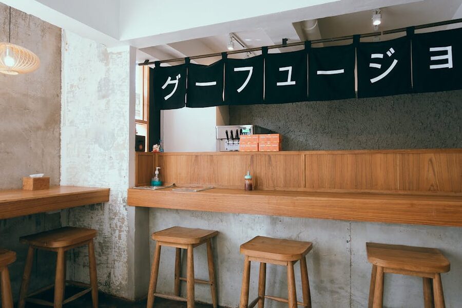 Japanese izakaya bar interior with wooden stools