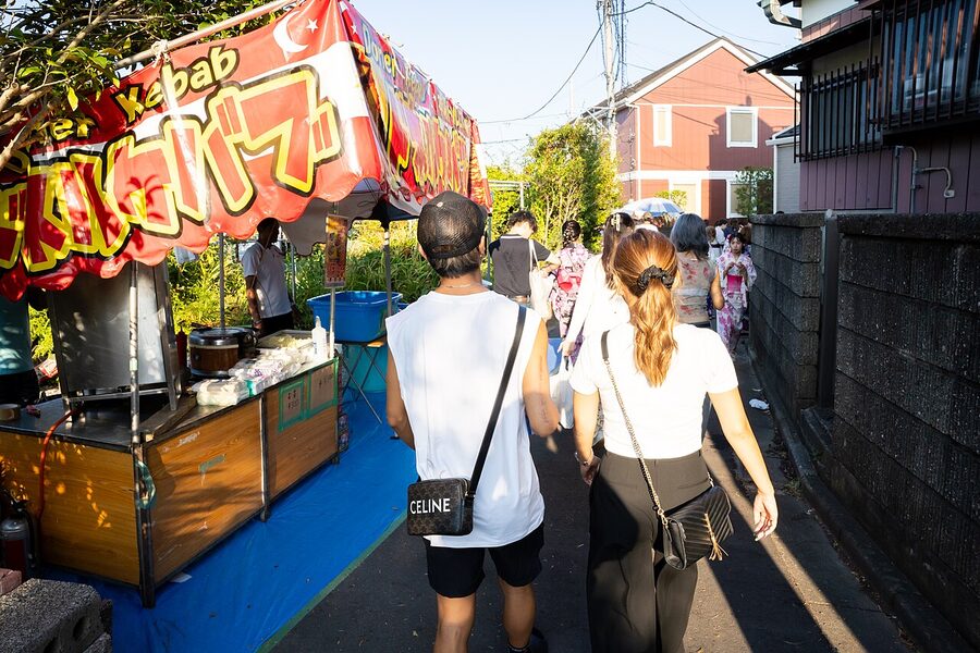 Viewers on the Edogawa River bank watching the festival at dusk