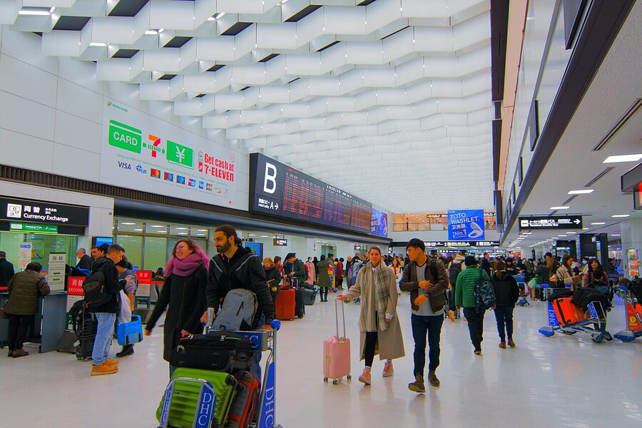 Arrival lobby at Narita Airport Terminal 2 with information desk and signage