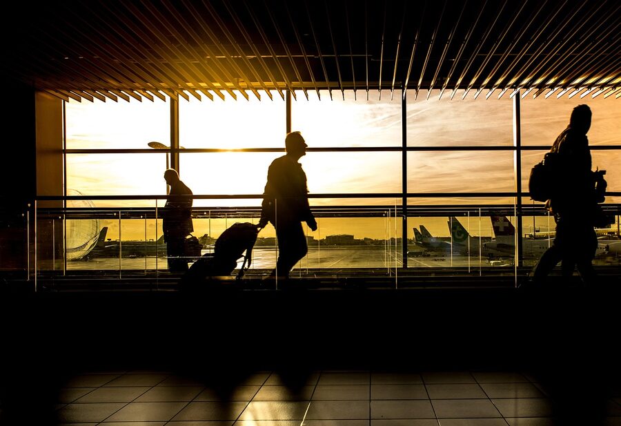 Traveller with luggage at airport terminal
