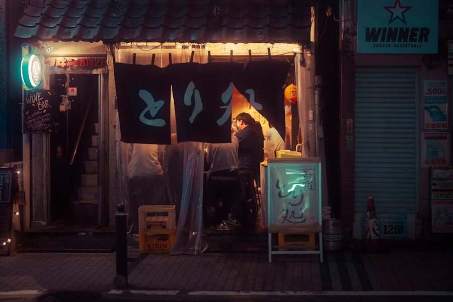 Cozy izakaya interior in Tokyo at night with warm lighting