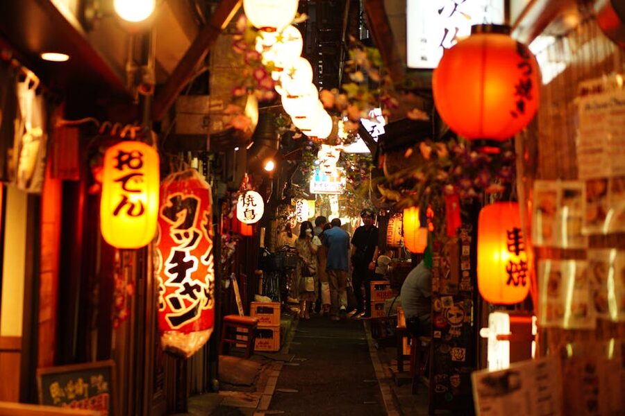 Narrow Shinjuku alley with glowing paper lanterns at night Tokyo