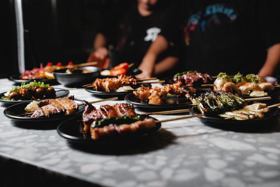 Assorted yakitori skewers on dark plates Japanese izakaya