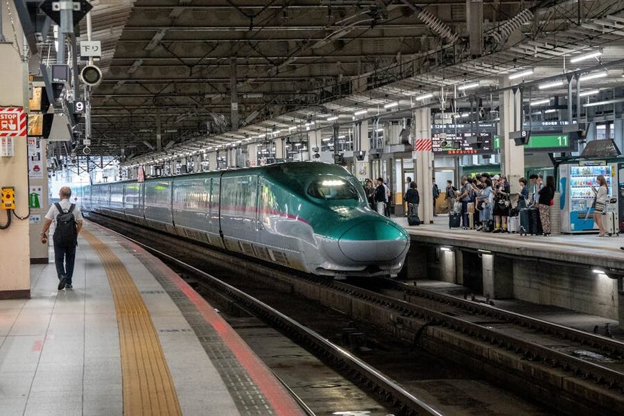 Shinkansen train arriving at a Japanese station