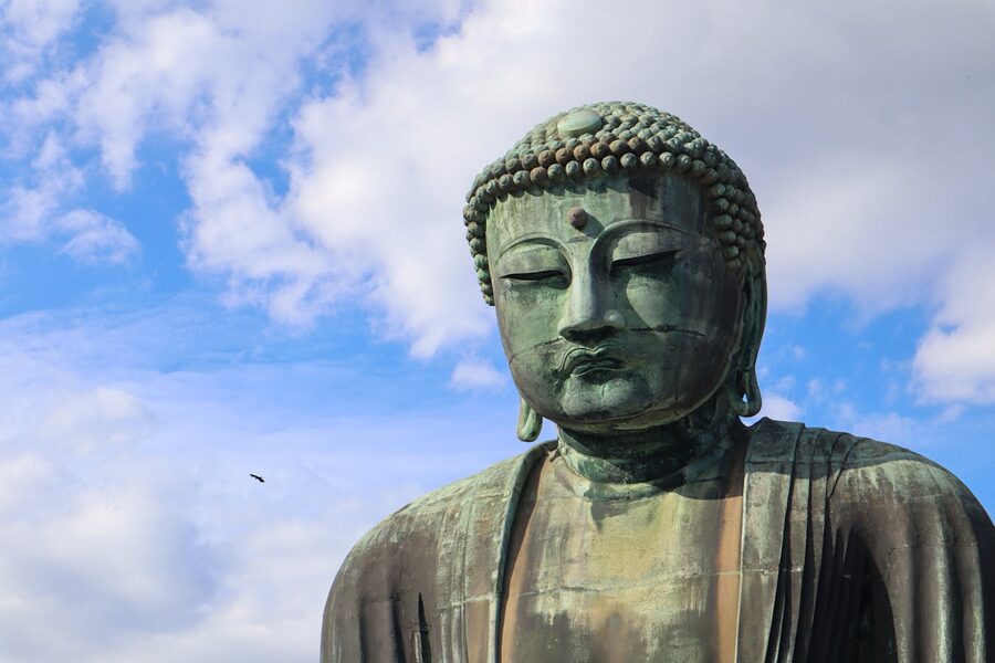Bronze Great Buddha of Kamakura under clear blue sky at Kotoku-in