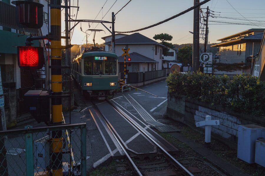 Street scene in Kamakura with a railway crossing at dawn