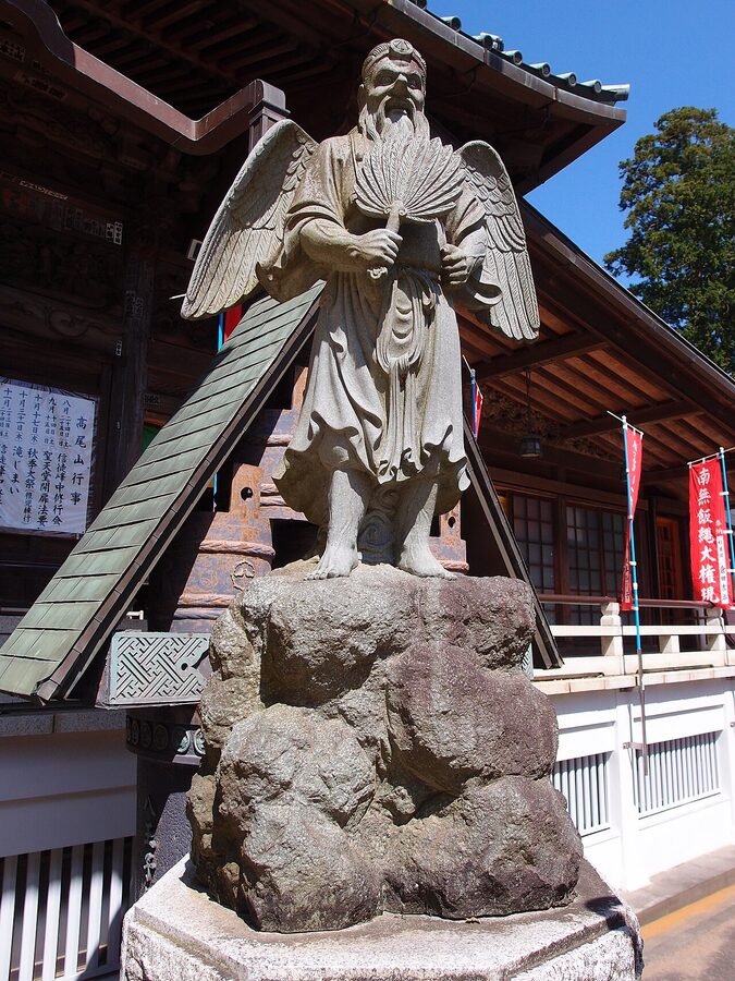 Bronze tengu statue at Yakuo-in Mount Takao with long red nose