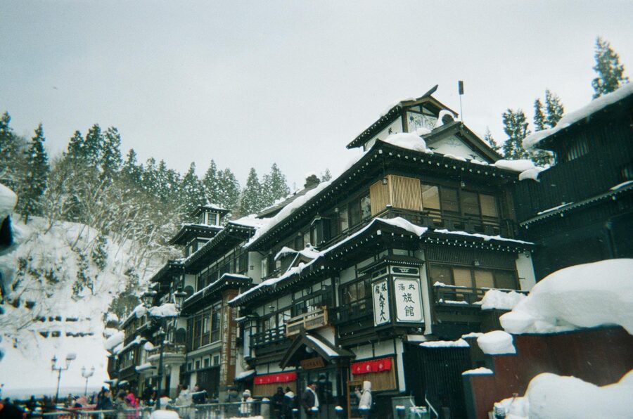 Traditional Japanese onsen town buildings covered in snow