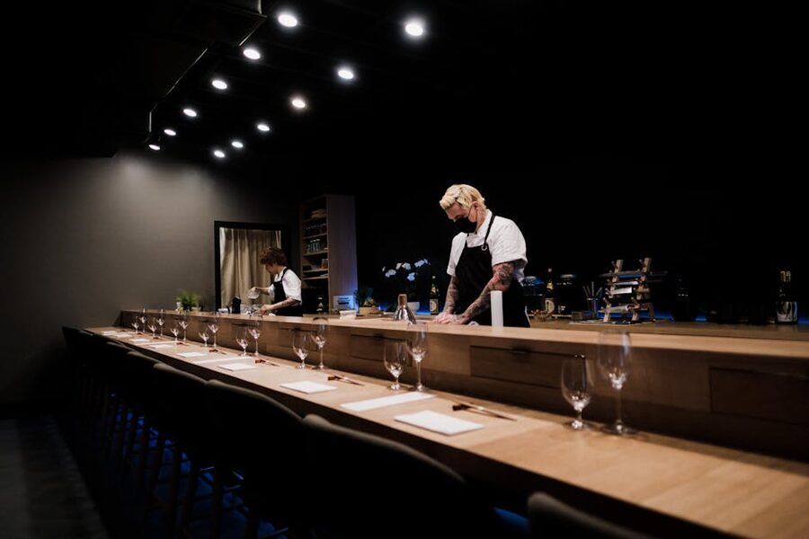 Chefs preparing sushi at an elegant omakase counter