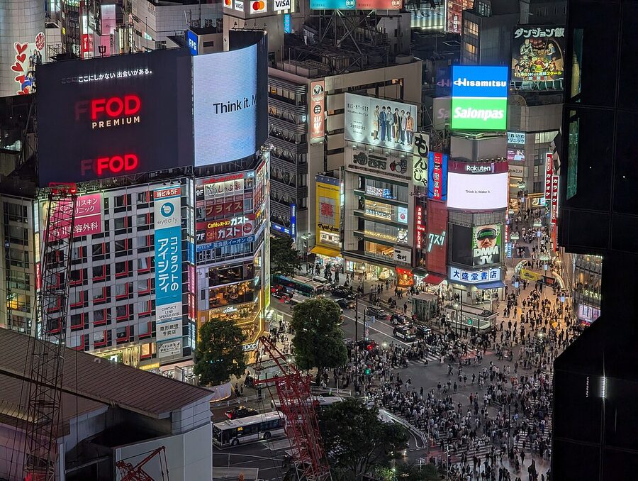 Shibuya Crossing at ground level as seen from the Shibuya Stream building walkway
