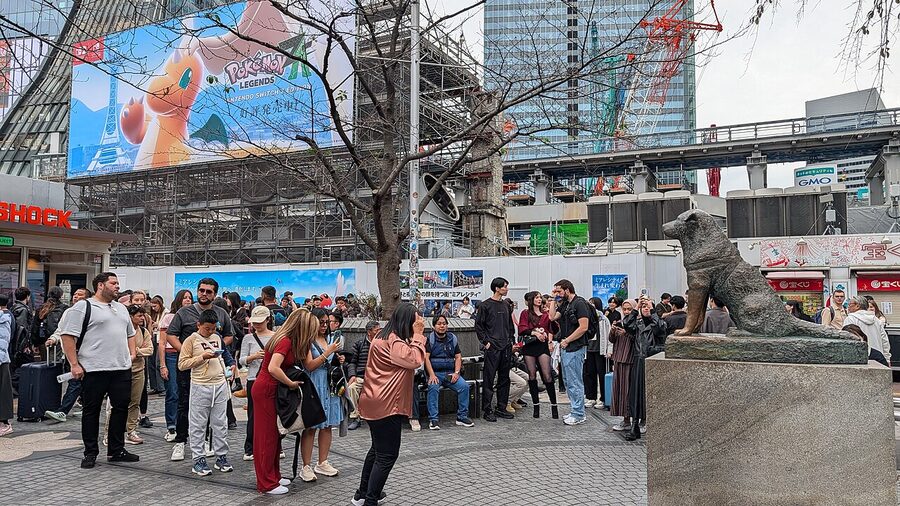 Tourists queueing to photograph the Hachiko statue in Shibuya, Tokyo