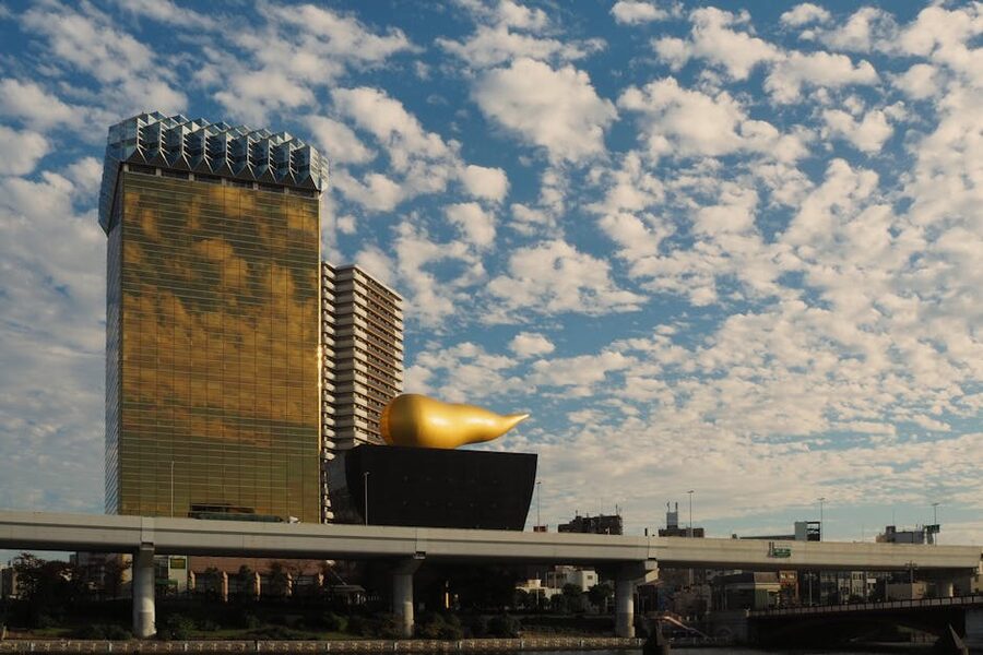 Asahi Beer Hall and Tokyo Skytree seen from across the Sumida River in daylight