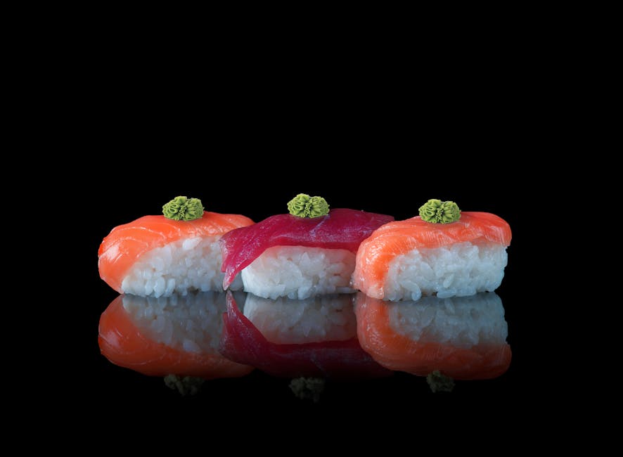 Salmon and tuna nigiri with a dab of wasabi