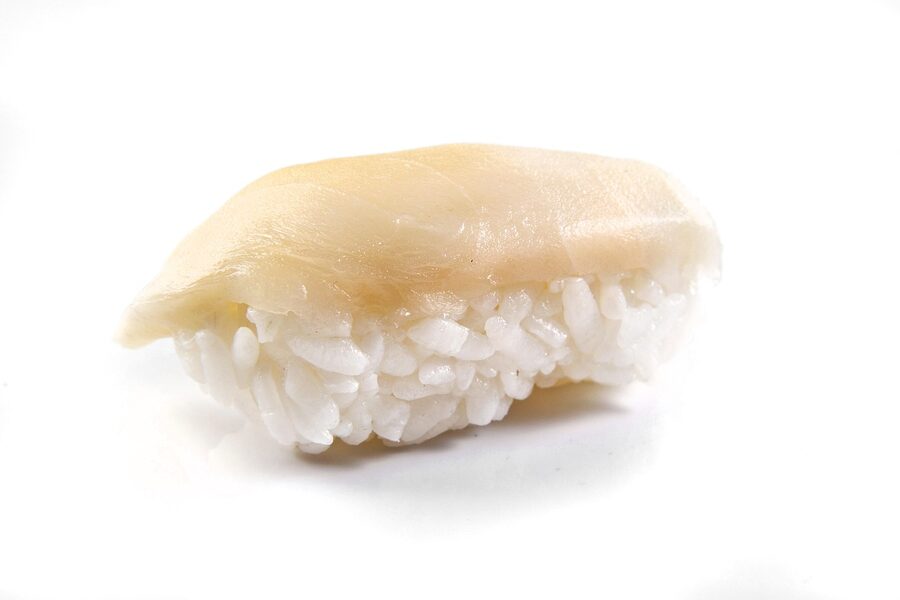Close-up nigiri sushi pieces on a white surface