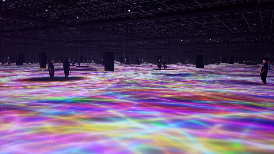 Visitors photographing immersive art at teamLab Planets Tokyo