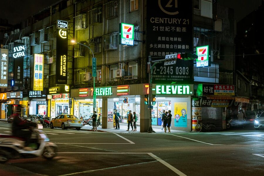 A 7-Eleven at night on a Tokyo street