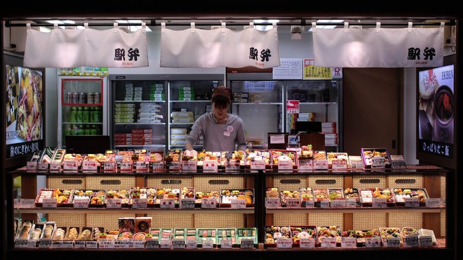 A worker arranging bento boxes in a Tokyo shop