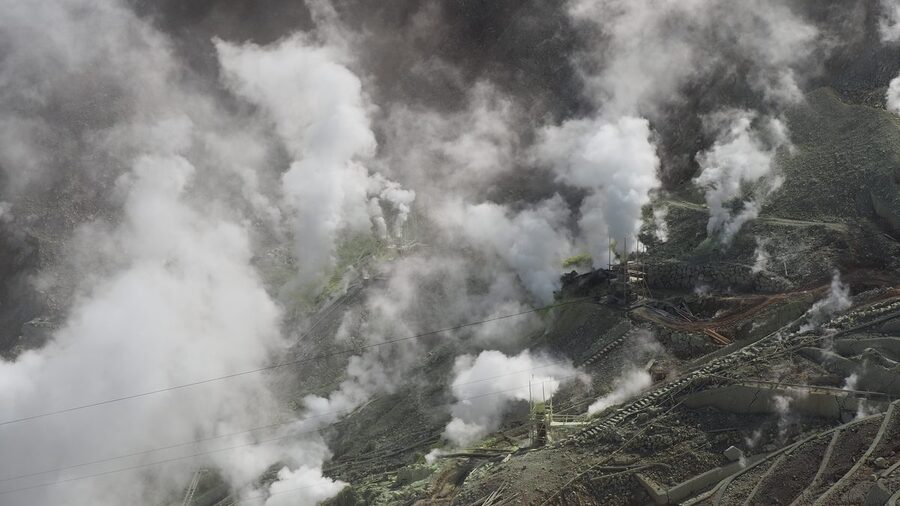 Owakudani volcanic valley in Hakone with sulphur vents and Mt Fuji in the distance