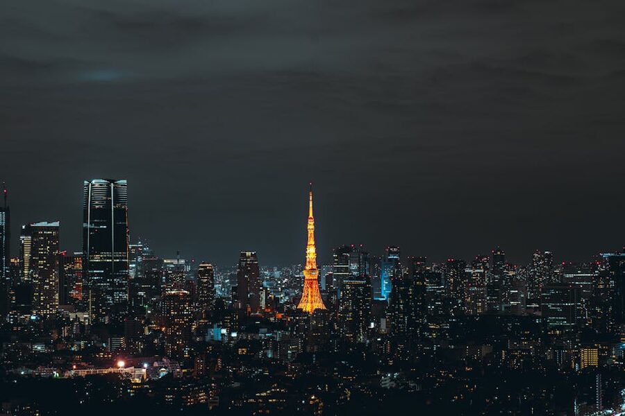 Tokyo Tower glowing orange against the night skyline of central Tokyo