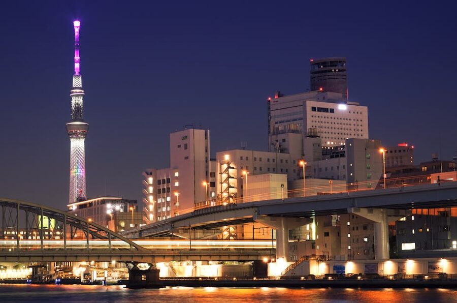 Tokyo Skytree and illuminated bridges at night over Sumida River