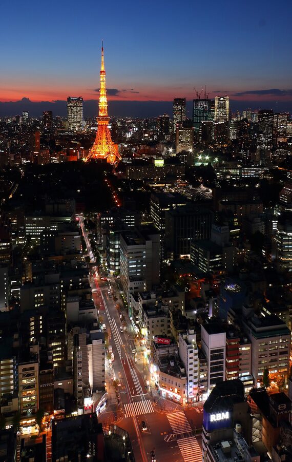 Tokyo Tower silhouetted at dusk with orange afterglow in the sky