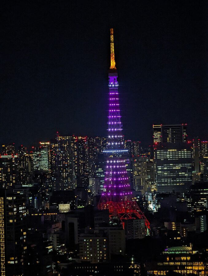 Tokyo Tower illuminated in cherry pink Infinity Diamond Veil lighting at night