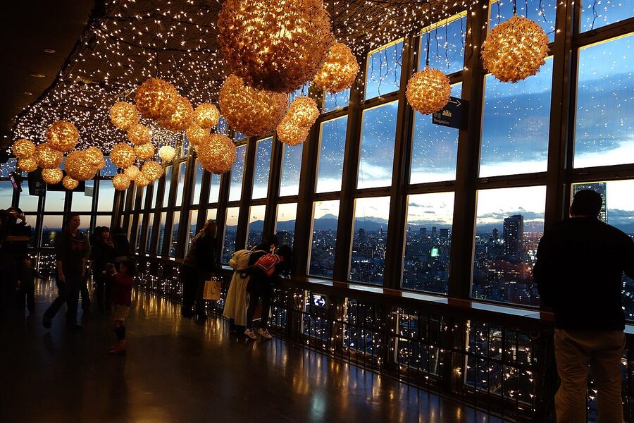 Interior of the Tokyo Tower Main Deck observation floor with windows looking over the city