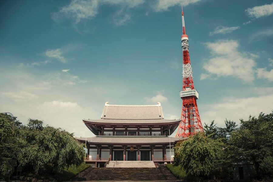 Tokyo Tower rising above the gate of Zojoji Temple in summer