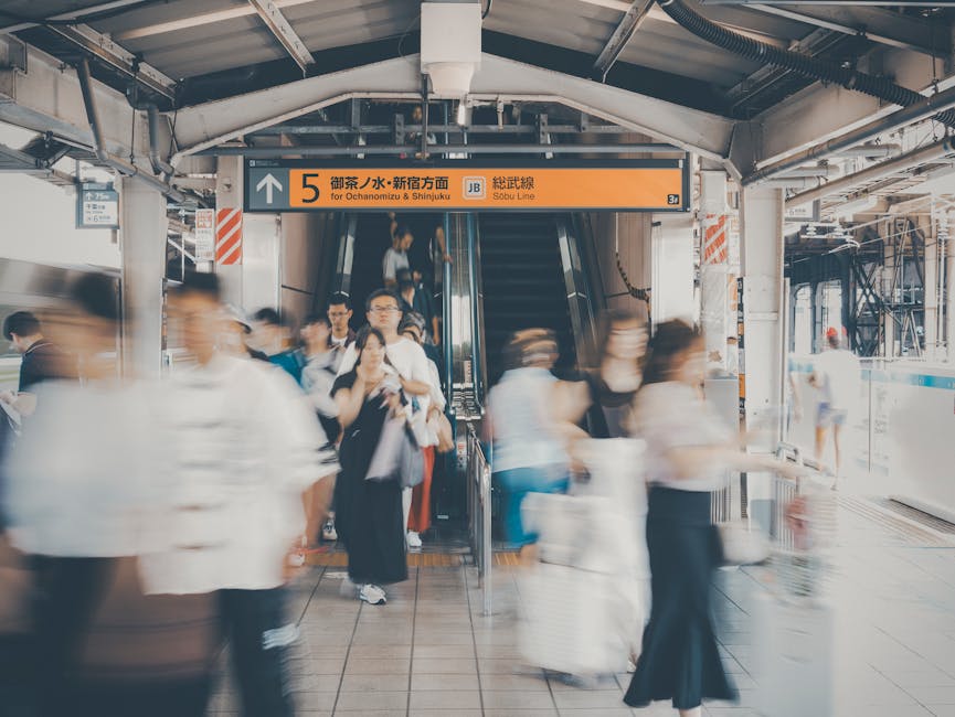 Shinjuku Station escalator with blurred commuters