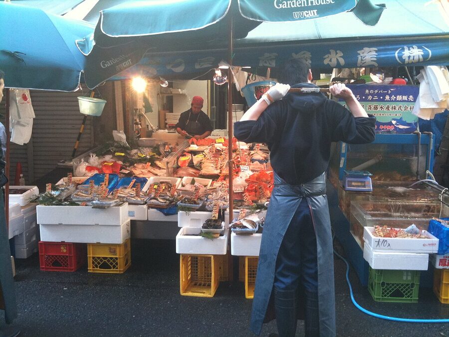 Fishmonger working behind a counter at Tsukiji, Tokyo