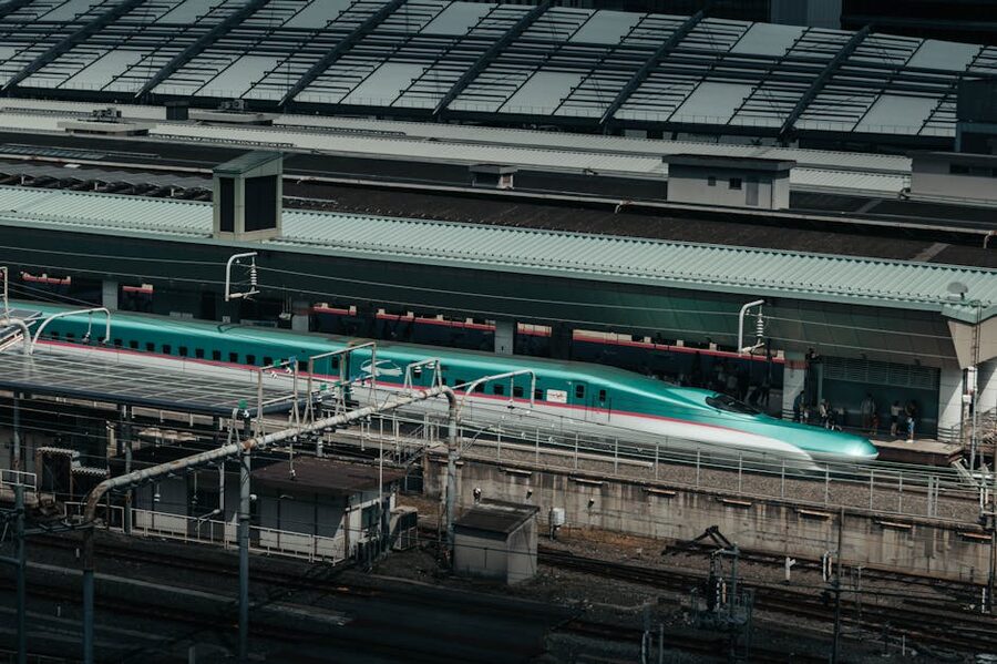 A white Shinkansen bullet train at Tokyo Station platform