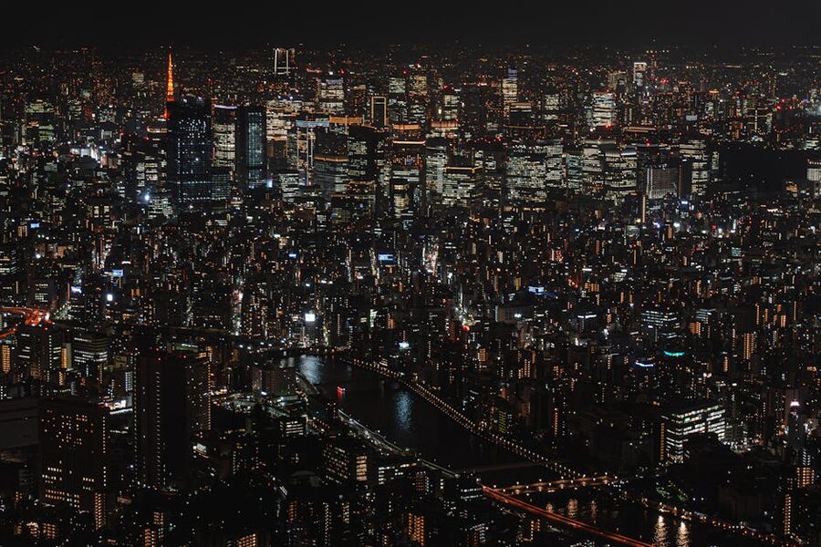 Tokyo skyline lit up at night, skyscrapers and distant bridges