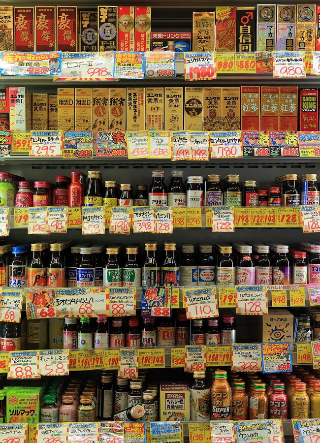 A conbini shelf stocked with sandwiches and drinks in Tokyo
