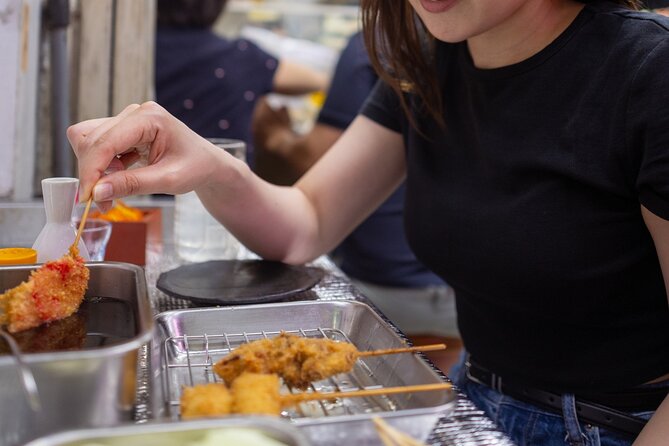 Shibuya by night in Small Groups: Neon Lights and Local Flavors - A traditional onigiri stop at Antenna 21
