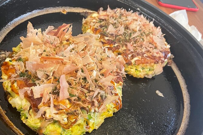 Small-Group Osaka-Style Okonomiyaki Cooking Class - Stir-fried pork and kimchi while the okonomiyaki cooks