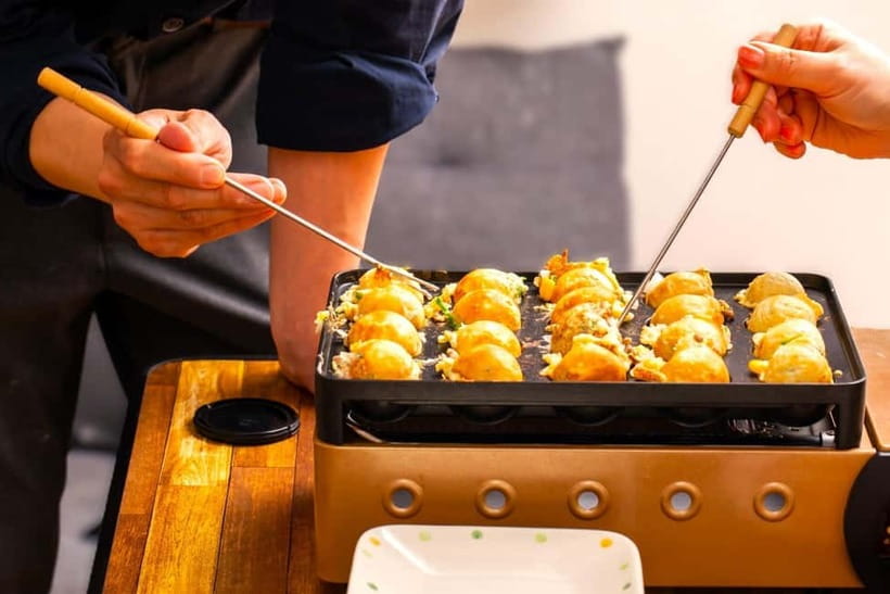 Takoyaki cooking experience in Kabukicho, Shinjuku - Turning batter into takoyaki in Kabukicho