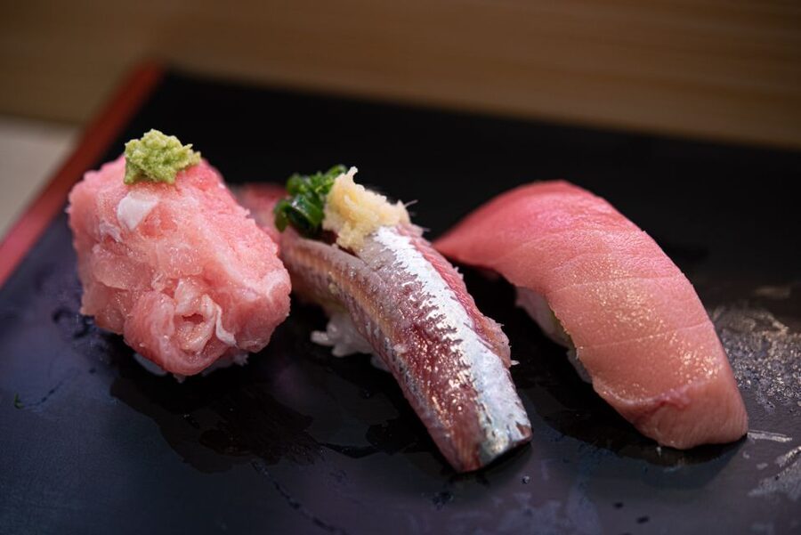 Tokyo: 2-Hour Asakusa Food Hunt & Cultural Tour - Standing sushi from a fish dealer